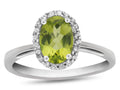 FJC Finejewelers 10k White Gold 7x5mm Oval Peridot with White Topaz accent stones Halo Ring