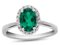 FJC Finejewelers 10k White Gold 7x5mm Oval Simulated Emerald with White Topaz accent stones Halo Ring