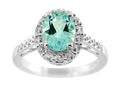 FJC Finejewelers 9x7mm Oval Blue Topaz and White Topaz Halo Ring